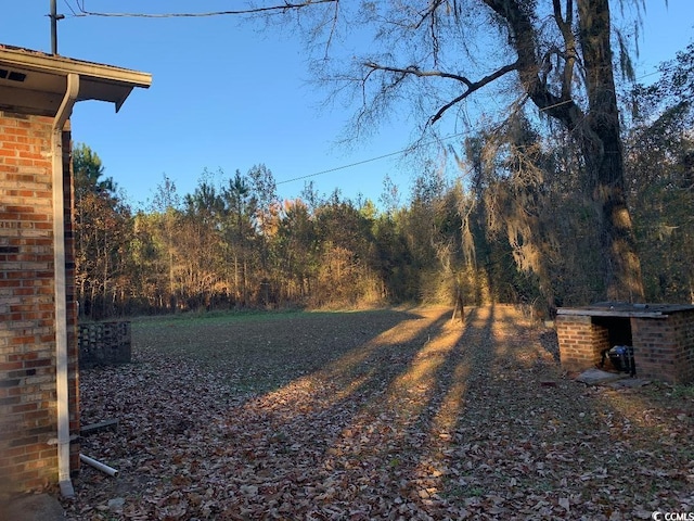 view of yard featuring a forest view