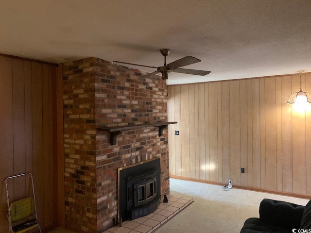 living room featuring wooden walls, light carpet, and ceiling fan