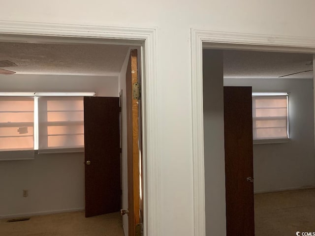 hallway with a textured ceiling