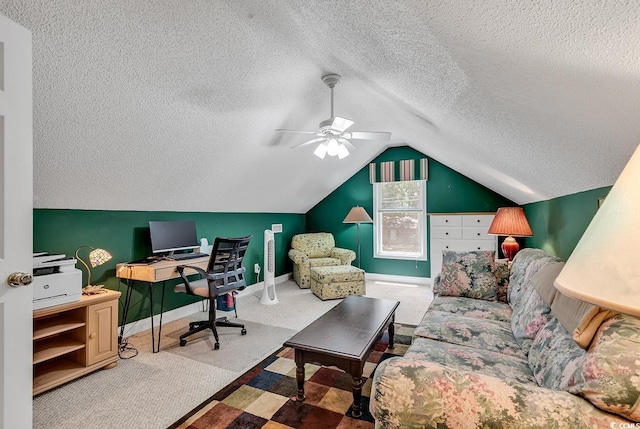 carpeted office space with ceiling fan, vaulted ceiling, and a textured ceiling