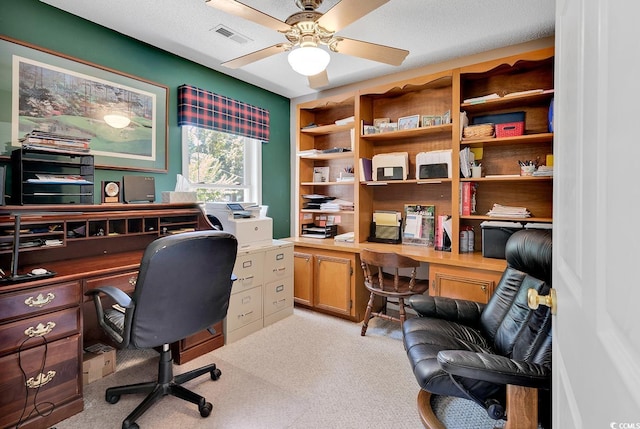 carpeted home office featuring ceiling fan