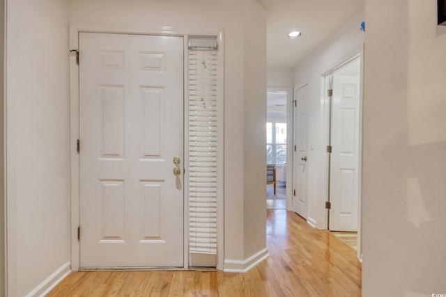 corridor with light hardwood / wood-style floors