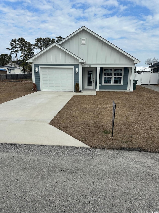 ranch-style home featuring a garage, fence, board and batten siding, and concrete driveway