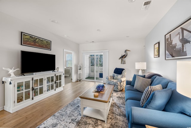 living room with visible vents and wood finished floors