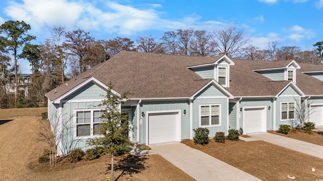 view of front of property featuring a garage, a shingled roof, board and batten siding, and concrete driveway