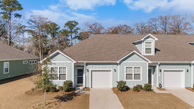 view of front facade featuring board and batten siding, concrete driveway, and an attached garage