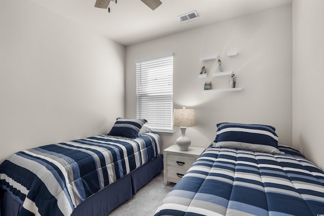 bedroom with a ceiling fan, light carpet, and visible vents