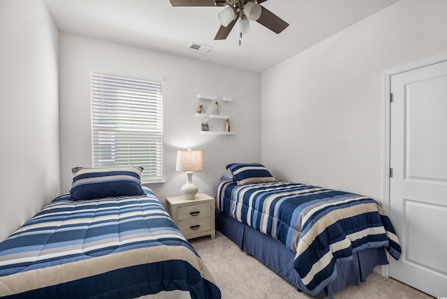 bedroom featuring a ceiling fan, light carpet, and visible vents