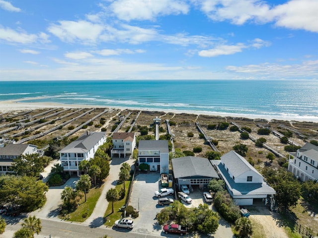 birds eye view of property with a beach view, a residential view, and a water view