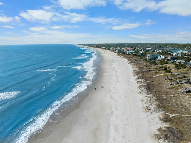 drone / aerial view with a water view and a view of the beach