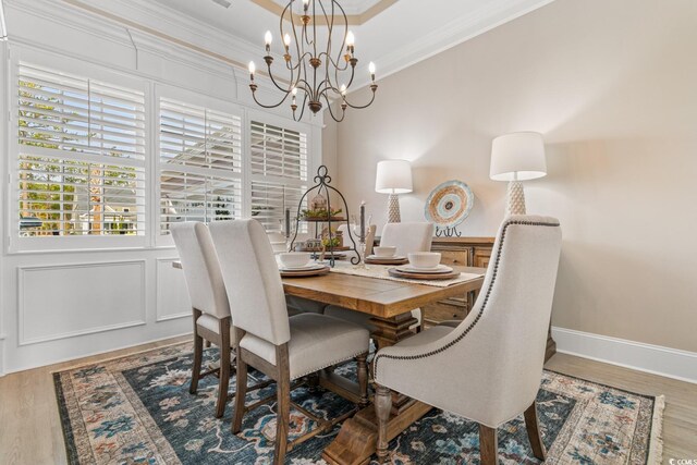 living room with crown molding, a towering ceiling, ceiling fan, beam ceiling, and light hardwood / wood-style floors