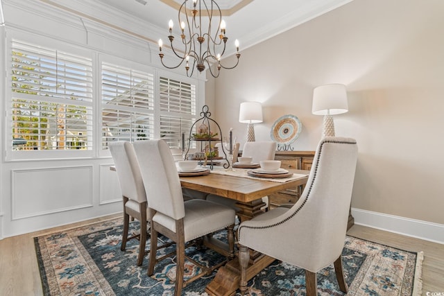 dining room with hardwood / wood-style flooring and crown molding