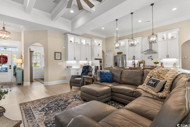 bathroom with hardwood / wood-style flooring, ornamental molding, a shower with door, and vanity