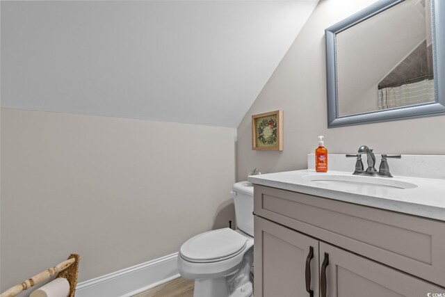 bathroom with vaulted ceiling, wood-type flooring, vanity, toilet, and a shower with curtain