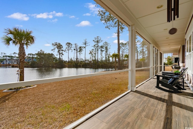 sunroom / solarium with a healthy amount of sunlight and a water view