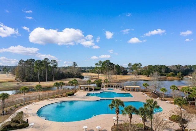 view of pool featuring a water view and a patio area