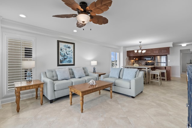 tiled living room featuring ornamental molding and ceiling fan with notable chandelier