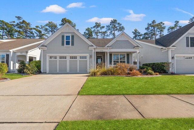 craftsman house featuring a garage and a front yard