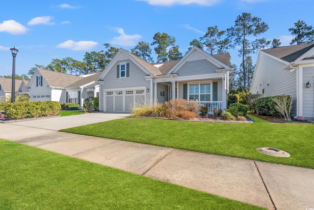 craftsman inspired home with a garage, a front lawn, and covered porch