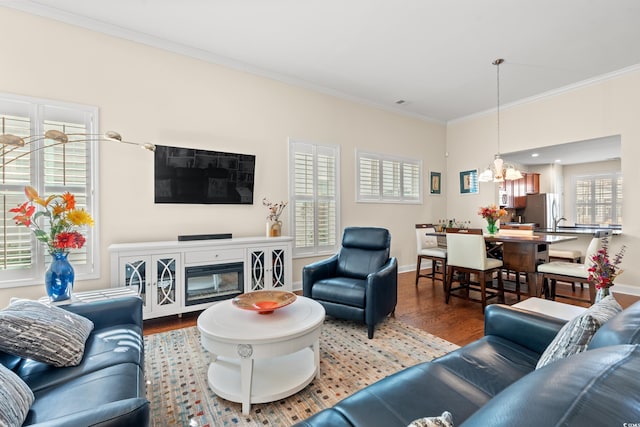 living room featuring wood-type flooring and ornamental molding