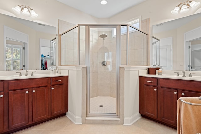 bathroom with vanity, tile patterned flooring, and a shower with door