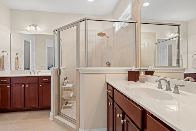 bathroom with tile patterned flooring, vanity, and walk in shower