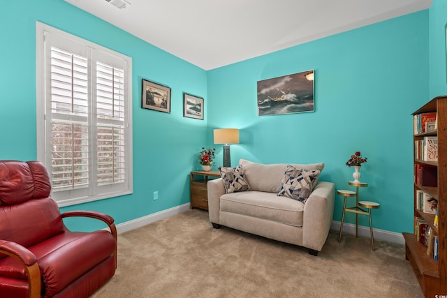 sitting room featuring light carpet