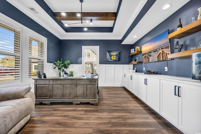 office space with ornamental molding, a healthy amount of sunlight, dark hardwood / wood-style floors, and a tray ceiling