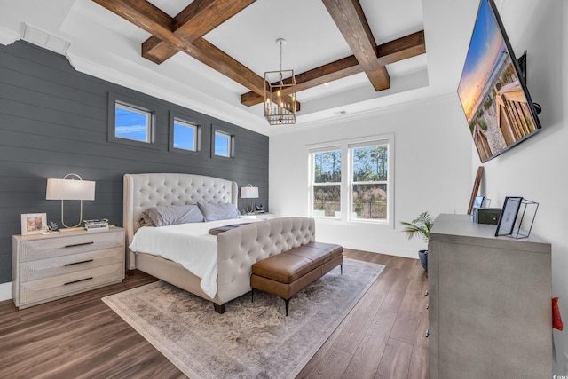 bedroom featuring dark hardwood / wood-style flooring, coffered ceiling, beamed ceiling, and an inviting chandelier