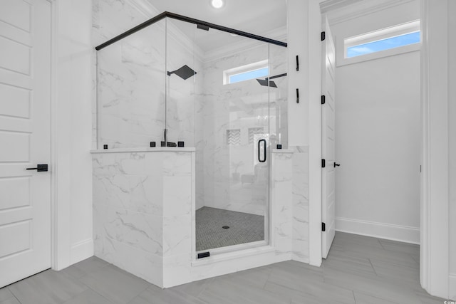 bathroom featuring a shower with door and crown molding