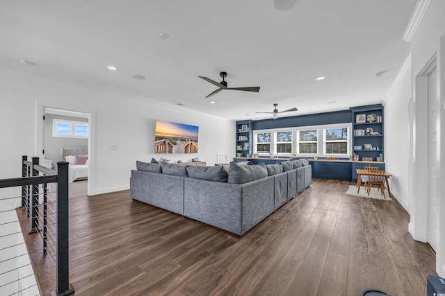 living room featuring ornamental molding, plenty of natural light, and dark hardwood / wood-style flooring