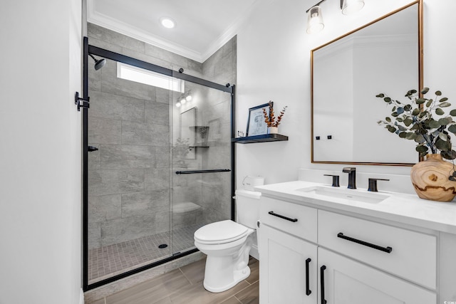 bathroom with ornamental molding, walk in shower, vanity, and toilet