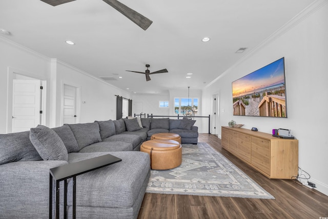 living room featuring ceiling fan, ornamental molding, and dark hardwood / wood-style floors