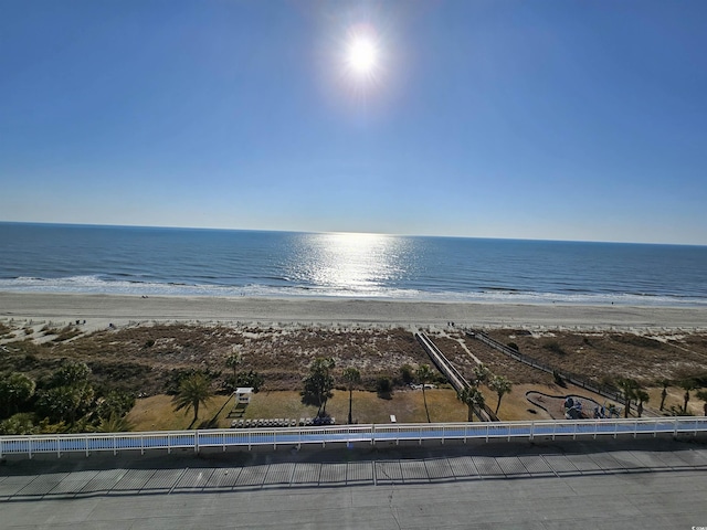 birds eye view of property featuring a water view and a beach view