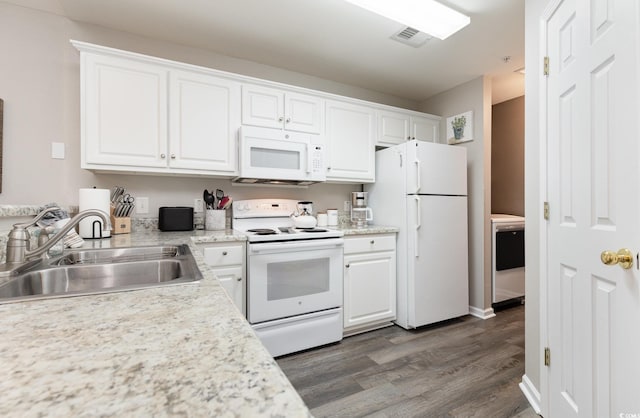 kitchen featuring white cabinetry, white appliances, washer / clothes dryer, and sink