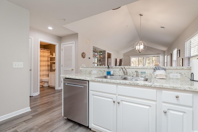 kitchen featuring pendant lighting, white cabinetry, dishwasher, lofted ceiling, and sink