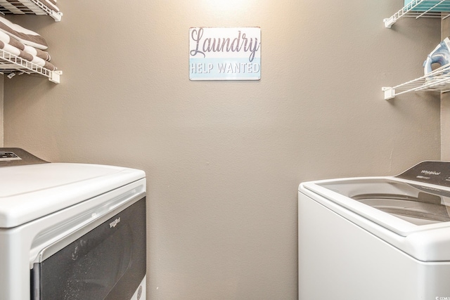 clothes washing area with washer and clothes dryer