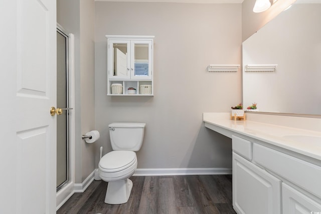 bathroom with vanity, wood-type flooring, an enclosed shower, and toilet