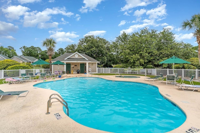 view of pool featuring a hot tub and a patio