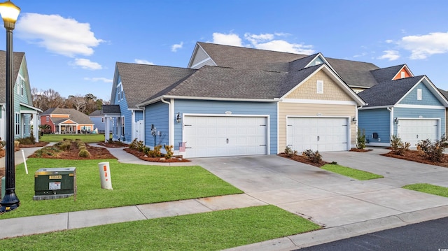 view of front facade with roof with shingles, an attached garage, a residential view, driveway, and a front lawn