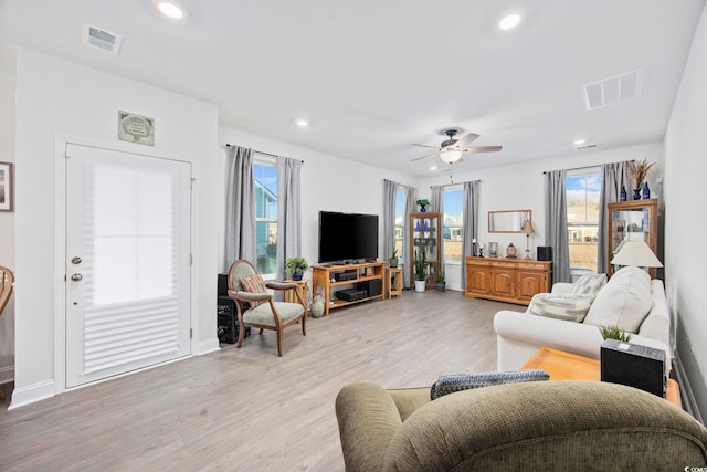 living room with light wood finished floors, visible vents, a ceiling fan, and recessed lighting