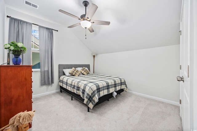 bedroom with lofted ceiling, light colored carpet, visible vents, ceiling fan, and baseboards