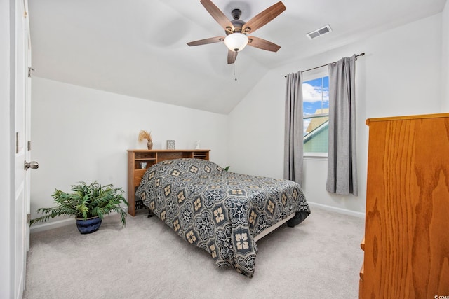 carpeted bedroom featuring lofted ceiling, visible vents, a ceiling fan, and baseboards