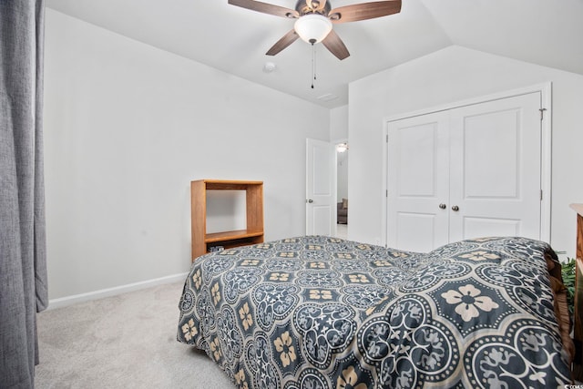 bedroom with light colored carpet, a ceiling fan, baseboards, vaulted ceiling, and a closet