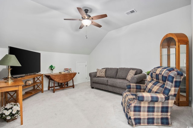 living room featuring light carpet, visible vents, baseboards, lofted ceiling, and ceiling fan