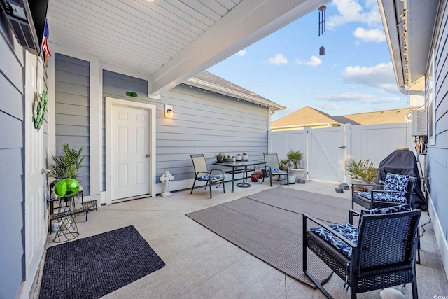 view of patio featuring a gate and fence