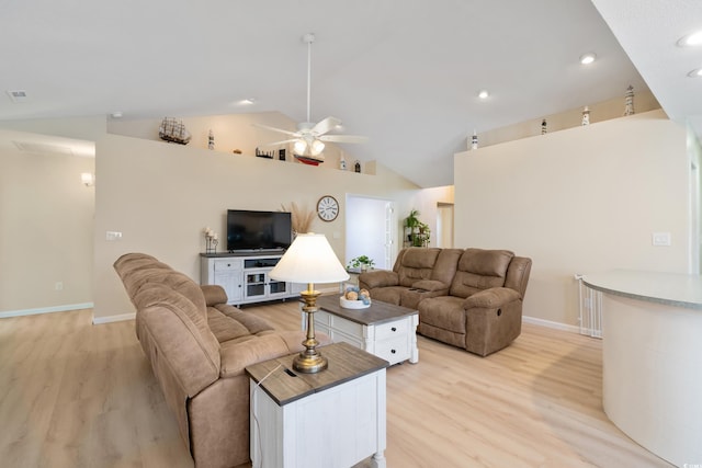 living room featuring light hardwood / wood-style floors, vaulted ceiling, and ceiling fan