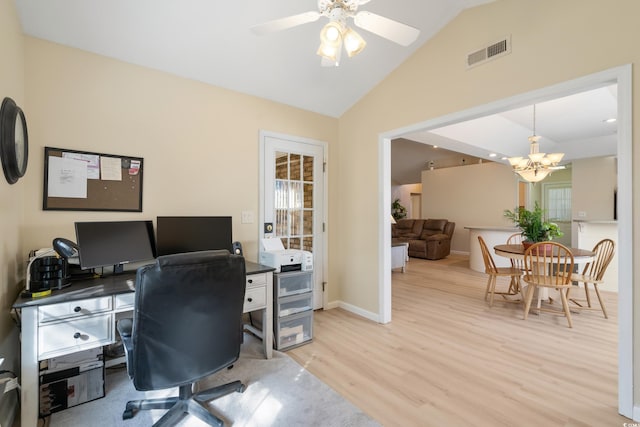 home office featuring ceiling fan with notable chandelier, light wood-type flooring, and vaulted ceiling