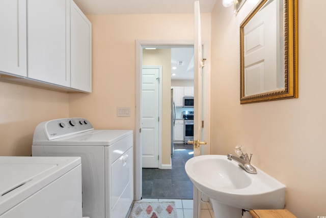 laundry area with sink, independent washer and dryer, and tile patterned floors