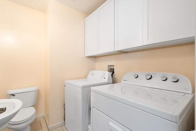 laundry room with light tile patterned flooring and separate washer and dryer